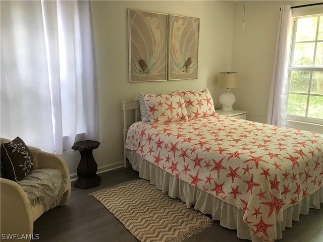 bedroom featuring dark hardwood / wood-style floors and multiple windows