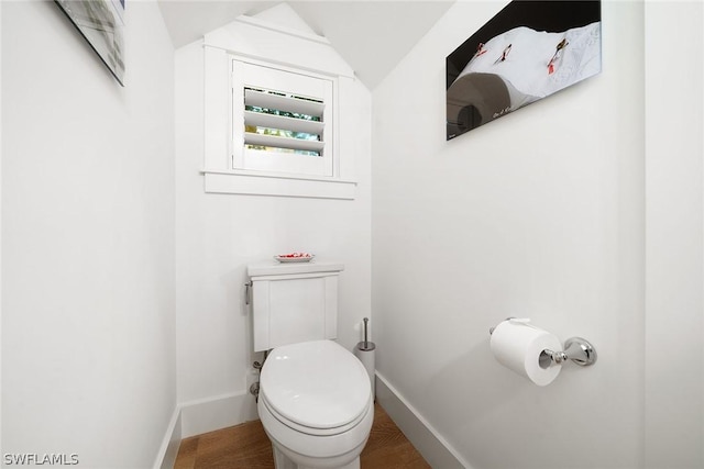 bathroom featuring lofted ceiling and toilet