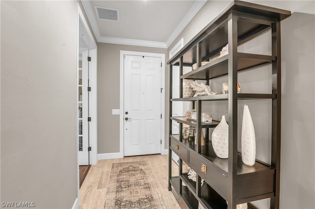 entryway featuring ornamental molding and hardwood / wood-style flooring