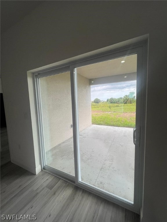 doorway with wood-type flooring