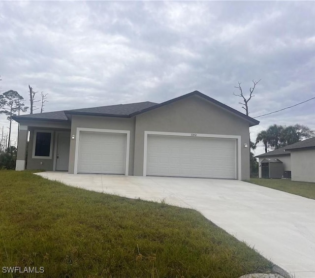 view of front of home with a front yard and a garage