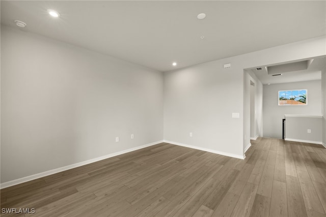 empty room featuring recessed lighting, baseboards, and dark wood-style flooring