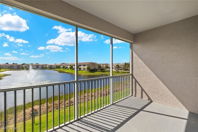 balcony featuring a water view and a residential view