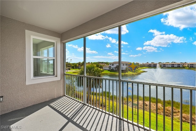 unfurnished sunroom featuring a water view