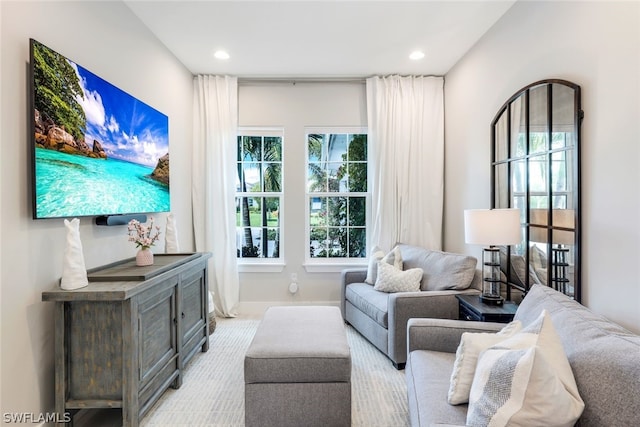 living room with a wealth of natural light and light colored carpet