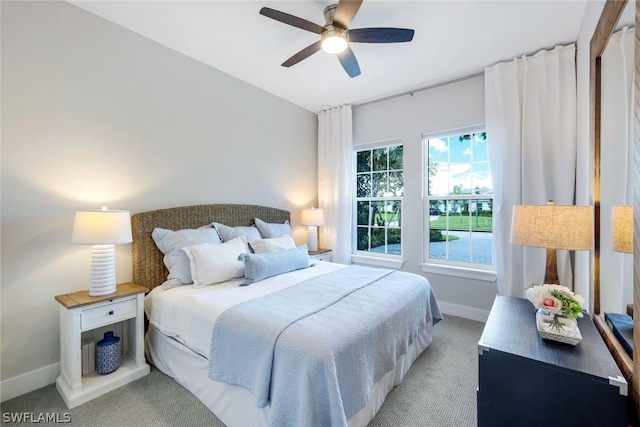 bedroom with ceiling fan and light carpet