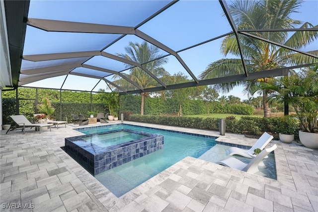 view of swimming pool featuring an in ground hot tub, glass enclosure, and a patio area