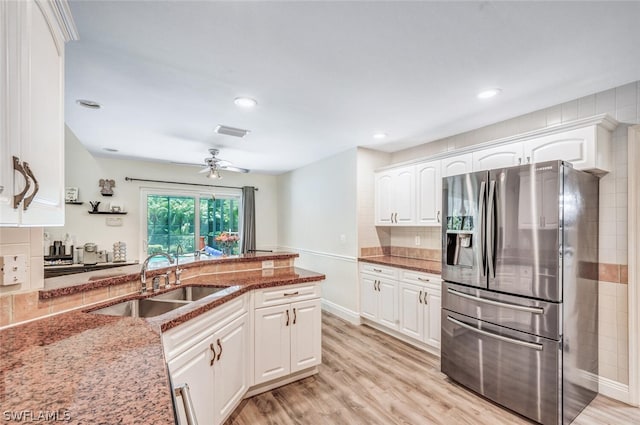 kitchen with white cabinetry, sink, stainless steel fridge with ice dispenser, dark stone counters, and light hardwood / wood-style floors