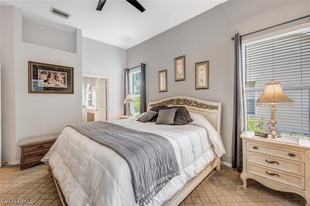 bedroom featuring ensuite bath and ceiling fan