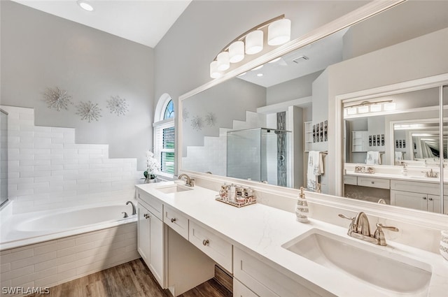 bathroom with vanity, plus walk in shower, and hardwood / wood-style flooring