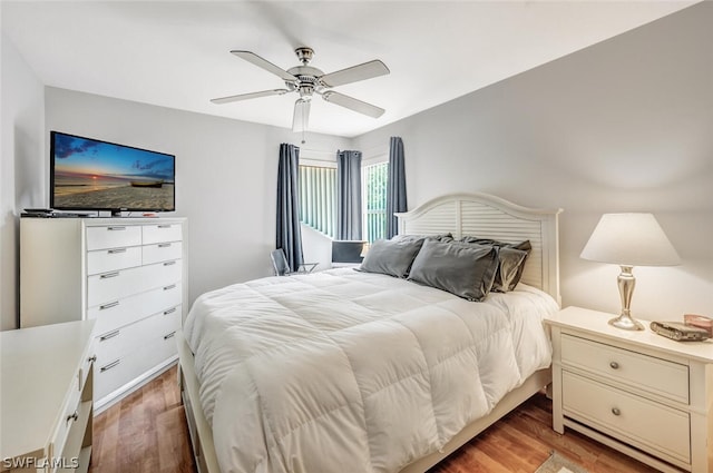 bedroom with ceiling fan and wood-type flooring