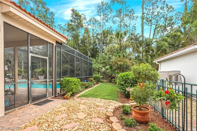 view of yard with glass enclosure