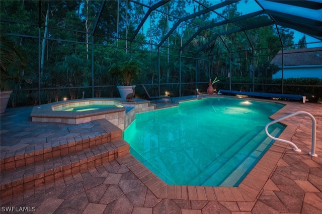 view of pool featuring an in ground hot tub, a patio, and a lanai