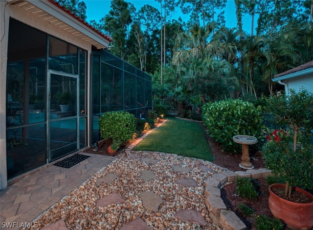 view of yard featuring glass enclosure