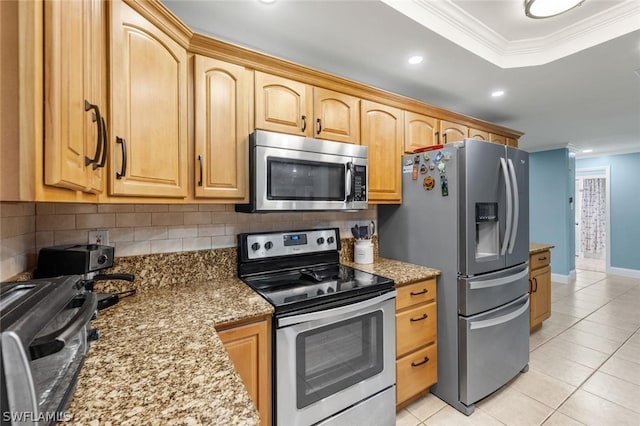 kitchen featuring decorative backsplash, light stone counters, ornamental molding, stainless steel appliances, and light tile patterned flooring