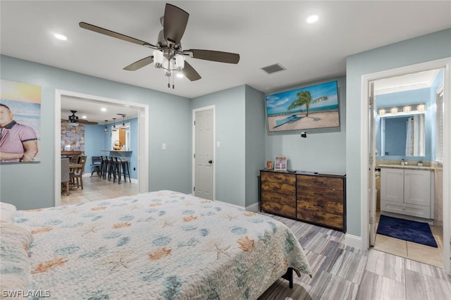 bedroom with ensuite bath and ceiling fan