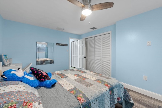 bedroom with ceiling fan, a closet, and hardwood / wood-style flooring