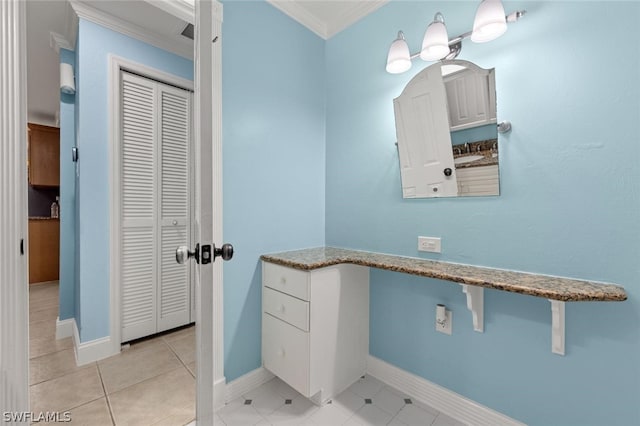 bathroom with tile patterned flooring and crown molding