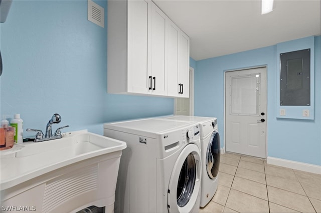 laundry room with cabinets, electric panel, sink, washing machine and dryer, and light tile patterned floors