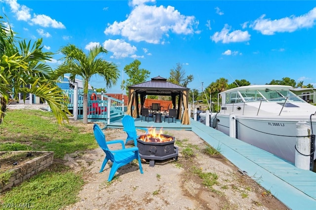 exterior space featuring a fire pit and a gazebo