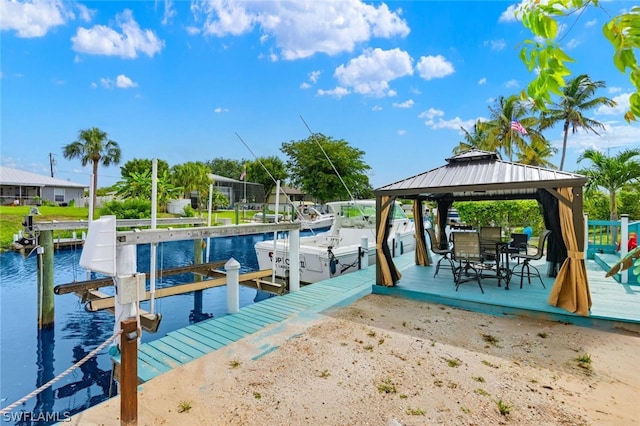 view of dock with a gazebo and a water view