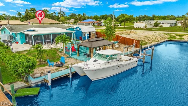 view of swimming pool featuring a sunroom, a dock, and a water view