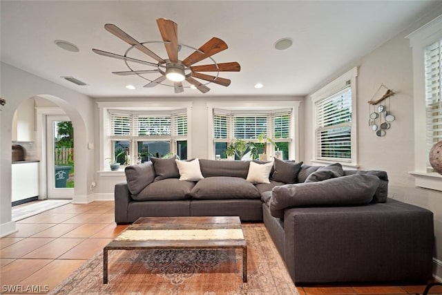 living room with ceiling fan and light tile patterned flooring