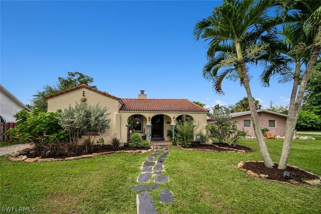 mediterranean / spanish-style house featuring a front lawn