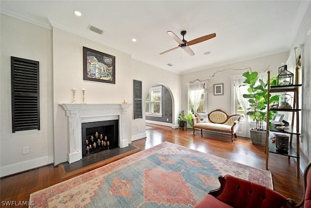 living room featuring ceiling fan, dark hardwood / wood-style floors, and ornamental molding