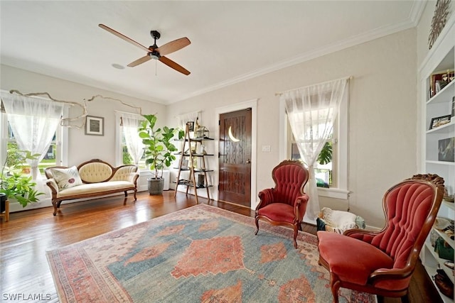 sitting room featuring ceiling fan, plenty of natural light, ornamental molding, and hardwood / wood-style flooring