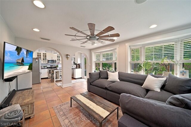 tiled living room featuring ceiling fan