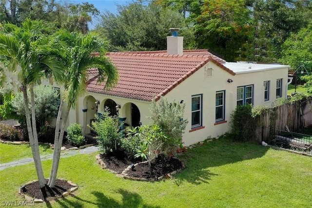 back of property featuring a yard