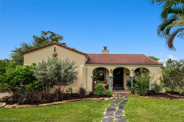 mediterranean / spanish house with a front yard