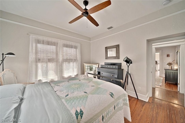 bedroom with ceiling fan and hardwood / wood-style floors