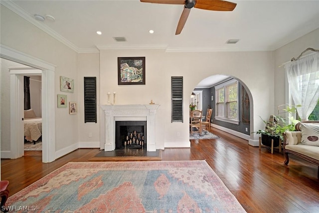 living room featuring crown molding, ceiling fan, and dark wood-type flooring