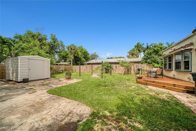 view of yard featuring a storage shed and a deck