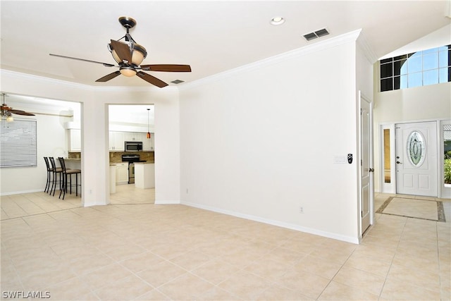 interior space featuring ceiling fan, light tile patterned flooring, and ornamental molding