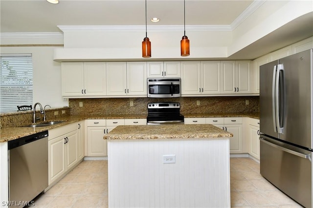 kitchen featuring light stone countertops, appliances with stainless steel finishes, tasteful backsplash, sink, and hanging light fixtures