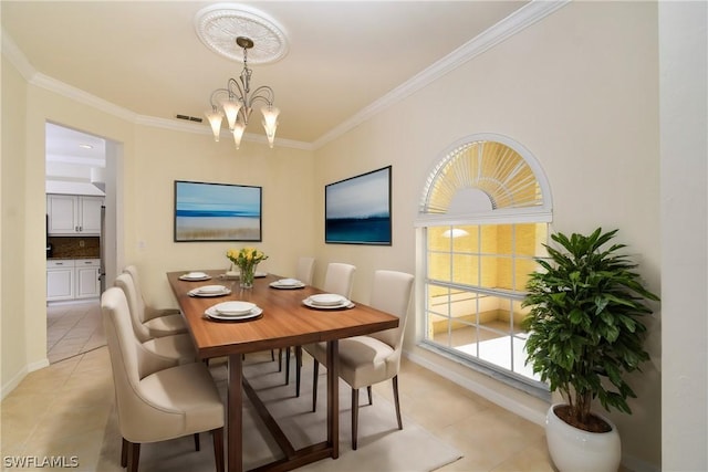 tiled dining area featuring a healthy amount of sunlight, crown molding, and a chandelier