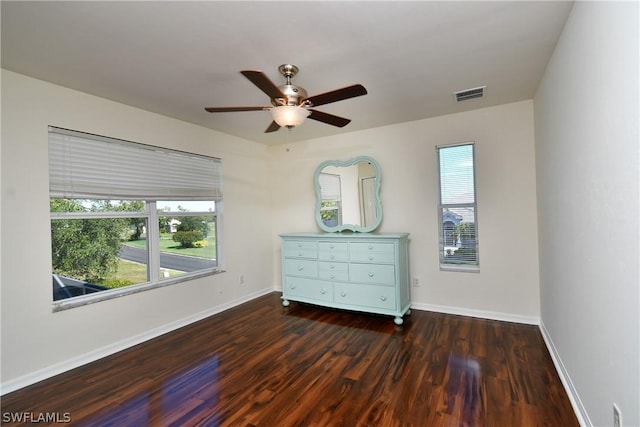 unfurnished bedroom featuring ceiling fan and dark hardwood / wood-style flooring