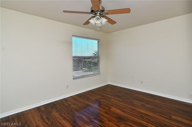 empty room with dark hardwood / wood-style floors and ceiling fan