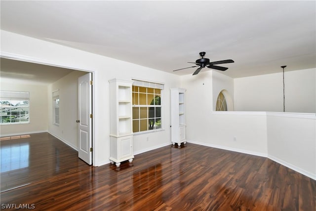 empty room featuring dark hardwood / wood-style flooring and ceiling fan