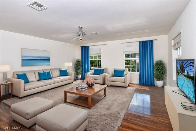 living room featuring dark hardwood / wood-style floors and ceiling fan