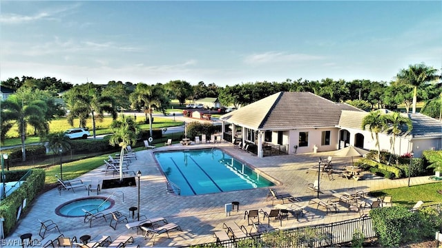 view of swimming pool featuring a patio area and a community hot tub