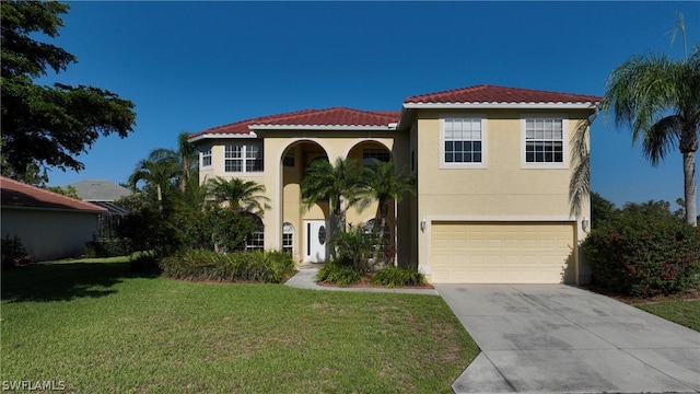 mediterranean / spanish-style home featuring a front lawn and a garage