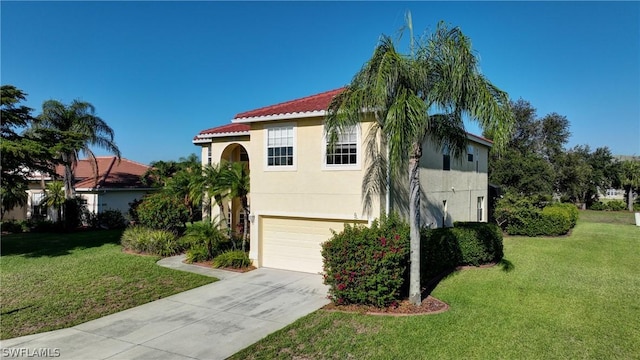 mediterranean / spanish-style house featuring a garage and a front lawn