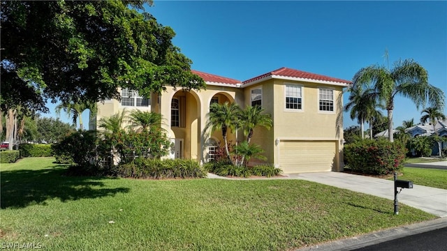 mediterranean / spanish home featuring a garage and a front lawn