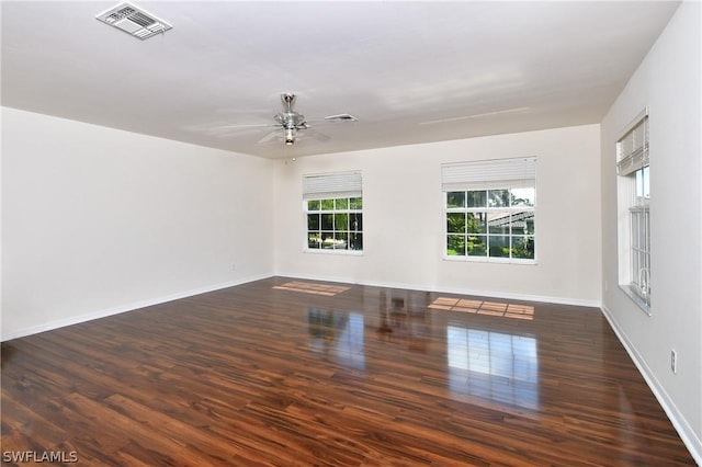 empty room featuring dark hardwood / wood-style flooring and ceiling fan