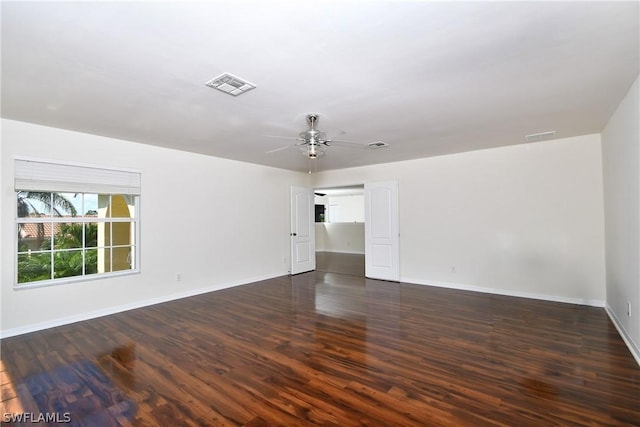 empty room featuring ceiling fan and dark wood-type flooring