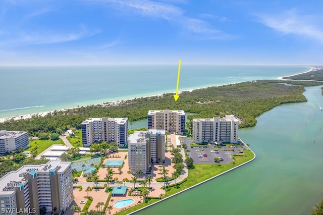 birds eye view of property with a view of the beach and a water view